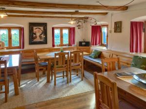 a dining room with wooden tables and chairs at Weitblick in Zenting