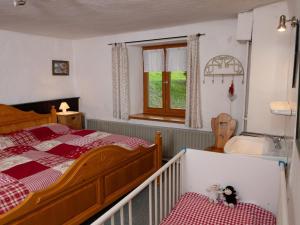 a bedroom with a bed and a sink and a tub at Weitblick in Zenting