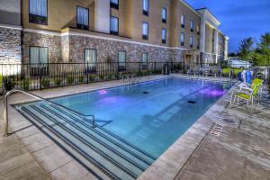 a large swimming pool in front of a building at Hampton Inn and Suites Ada in Ada