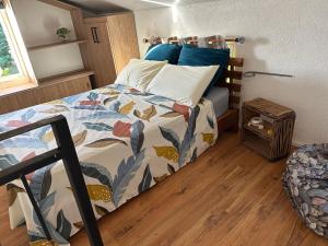 a bedroom with a bed with a colorful comforter at Kreolia Blue-Waters in Trou d'Eau Douce