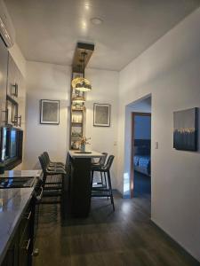 a kitchen and dining room with a table and chairs at Sea view house in Utila