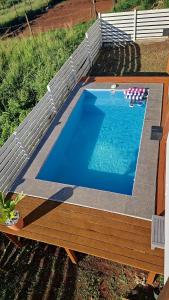 a swimming pool with a wooden deck and a swimming pool at Sea view house in Utila