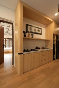 a kitchen with a stove top oven in a room at Lavana Villa by Raminten in Yogyakarta