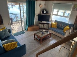 a living room with a couch and a table at Kreolia Blue-Waters in Trou d'Eau Douce