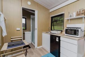 a kitchen with a counter with a microwave on it at 8 Farm Macadamia Plantation 2 by Tiny Away in Cumbalum