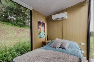 a bedroom with a bed and a window at 8 Farm Macadamia Plantation 2 by Tiny Away in Cumbalum +12 photos