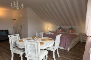 a bedroom with a table and chairs and a bed at Agritourism, family studio in Ładzin