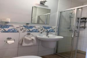 a bathroom with a toilet and a sink and a shower at Agritourism by the sea in Ładzin +11 photos