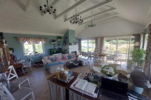 a living room with a couch and a table at Agritourism by the sea in Ładzin