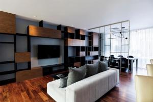 a living room with a white couch and a tv at Doubletree By Hilton Mexico City Santa Fe in Mexico City