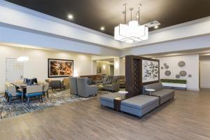 a lobby with a waiting room with couches and tables at Doubletree by Hilton Pleasant Prairie Kenosha, WI in Pleasant Prairie