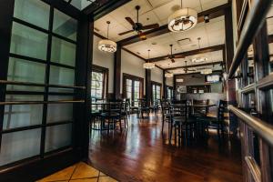 a dining room with tables and chairs and windows at Doubletree by Hilton Pleasant Prairie Kenosha, WI in Pleasant Prairie