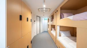 a dorm room with bunk beds and a hallway at CoZzzee Hostel in Singapore +9 photos