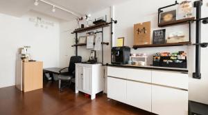 a coffee shop with a counter and a chair in a room at CoZzzee Hostel in Singapore