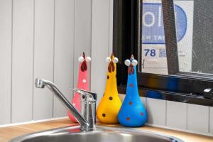 three bowling pins sitting on top of a kitchen sink at Clarence Farm Stay by Tiny Away in Maclean