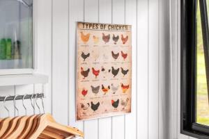 a picture of different types of chickens hanging on a wall at Clarence Farm Stay by Tiny Away in Maclean +27 photos