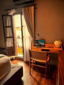 a room with a desk with a computer and a window at Hotel Bitos Boutique in San Miguel de Allende