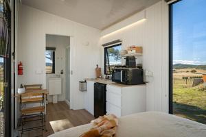 a room with a kitchen with a counter and a microwave at Clover at Lexington Park by Tiny Away in Tarlo +43 photos