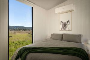 a bedroom with a bed with a picture of a dog at Myrtle at Lexington Park in Tarlo