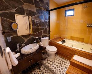 a bathroom with a tub and a toilet and a sink at Hotel Bitos Boutique in San Miguel de Allende +61 photos