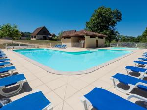 a large swimming pool with blue lounge chairs at Lac Bleu Nr 38 in Lacapelle-Marival