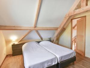 a bedroom with a white bed in a attic at Lac Bleu Nr 38 in Lacapelle-Marival +25 photos