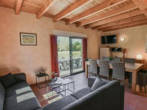 a living room with a couch and a table at Lac Bleu Nr 38 in Lacapelle-Marival