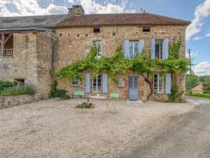 an old stone house with chairs in front of it at Lavende in Dégagnac