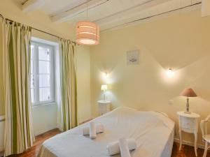 a bedroom with a white bed and a window at Lavende in Dégagnac +36 photos