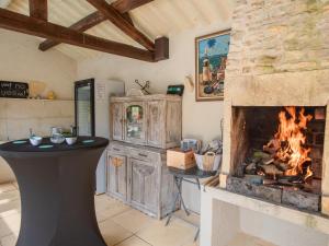 a living room with a fireplace and a stove at Tournesol in Dégagnac