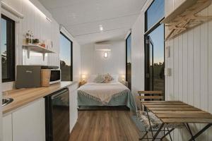a bedroom with a bed in a small room at The High Country Views Escape by Tiny Away in Table Top