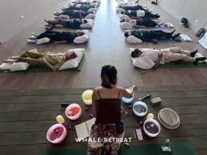 a group of people laying on the floor in a room at Whale Retreat Destination in Hat Yai