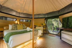 a bedroom in a tent with a bed and a piano at Tamborine Mountain Glades in Mount Tamborine +48 photos