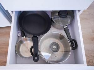a white drawer filled with pots and pans at Little Argyle Tiny House by Tiny Away in Coonabarabran