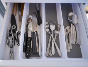 a drawer filled with utensils and cutlery at Little Argyle Tiny House by Tiny Away in Coonabarabran