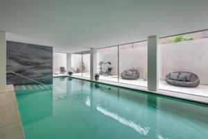 a swimming pool with two tubs in a house at Hilton Lake Como in Como