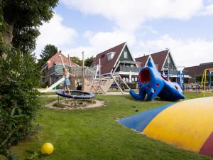 a young girl is playing on a playground at Wadden Lodge Living in Westerland