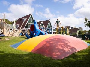 a child is on a playground with a slide at Wadden Lodge Plus in Westerland