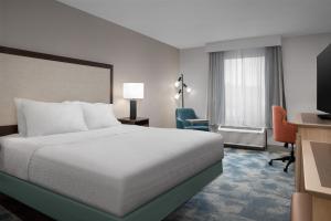 a hotel room with a bed and a desk and a television at Hampton Inn Yemassee/Point South, Sc in Yemassee