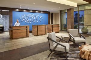 a lobby with a man standing behind a podium at Homewood Suites by Hilton San Diego Hotel Circle/SeaWorld Area in San Diego