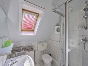 a white bathroom with a toilet and a sink at Poldergeluk in Ooltgensplaat +43 photos