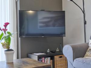 a living room with a large flat screen tv at Poldergeluk in Ooltgensplaat