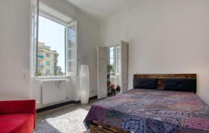 a bedroom with a large bed and a red couch at Casa Garibotti in Recco