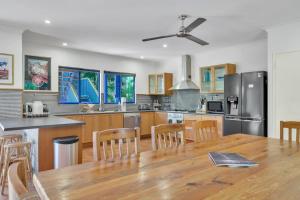 a large kitchen with a wooden table and a dining room at The Zoo House in Broome