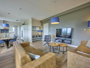 a living room with a couch and a table at SeaLuxe Residence 27C in Colijnsplaat