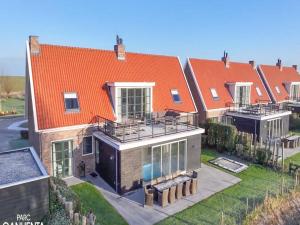 an aerial view of a house with an orange roof at Zwembadvilla in Colijnsplaat