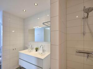 a bathroom with two sinks and a shower at SeaLuxe Residence 27C in Colijnsplaat +30 photos