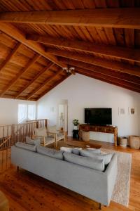 a living room with a large couch and a tv at Norfolk House in Dunsborough +15 photos