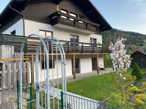 a building with a balcony on top of it at Villa Bellevue Apartment 1 Deluxe Apartment in Ossiach