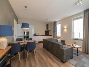 a living room with a couch and a table at La Mer Luxe in Colijnsplaat